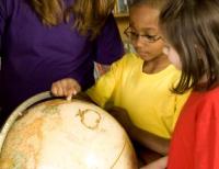 Children learning with globe