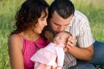 Photo of couple with man kissing baby