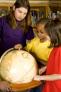 Children learning with globe
